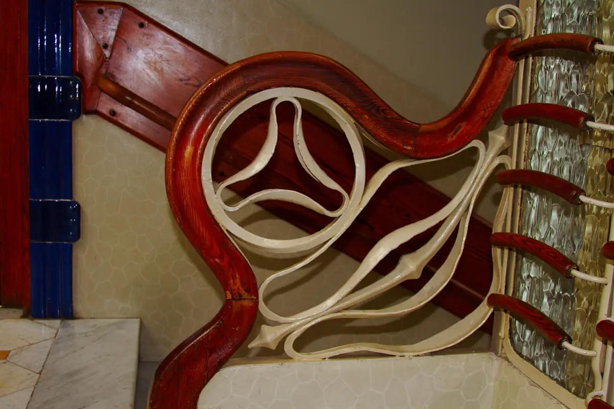 The carved wooden handrail of the staircase